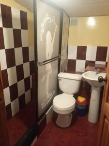 a bathroom with a toilet and a sink at Departamento MEDIO DIA in Quito