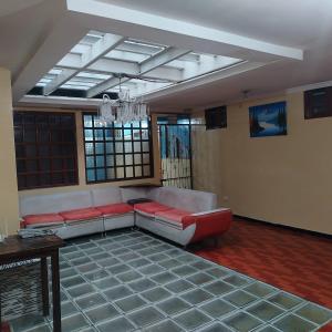 a living room with a couch and a chandelier at Departamento MEDIO DIA in Quito