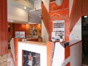 a restaurant with a counter with a sign on it at Roemah Djogja Inn Seturan Raya RedPartner in Seturan