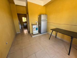 a kitchen with a refrigerator and a table in a room at Departamento Cómodo y Accesible in Humahuaca