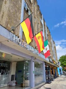 a building with flags on the side of it at Hotel La Paz in Guadalajara