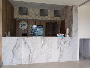 a marble counter in a lobby with a clock at Hotel La Paz in Guadalajara