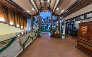 a hallway of a house with a tiled floor at Sada Hotel in Luang Prabang +118 photos