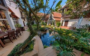 a courtyard with a pond in the middle of a building at Sada Hotel in Luang Prabang