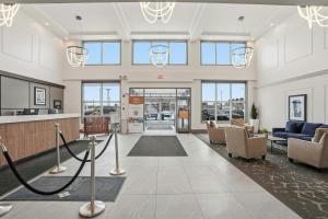 a lobby of a building with couches and chairs at Sandman Hotel Saskatoon in Saskatoon