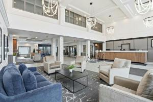 a large living room with couches and chairs at Sandman Hotel Saskatoon in Saskatoon