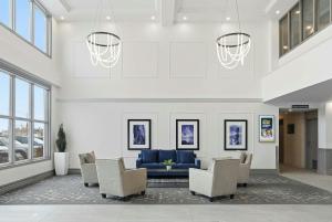 a lobby with a blue couch and chairs at Sandman Hotel Saskatoon in Saskatoon