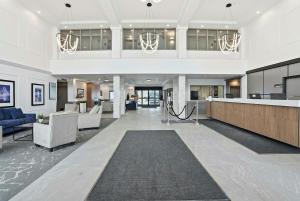 an office lobby with a reception desk and chairs at Sandman Hotel Saskatoon in Saskatoon