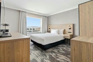 a hotel room with a bed and a large window at Sandman Hotel Saskatoon in Saskatoon +48 photos