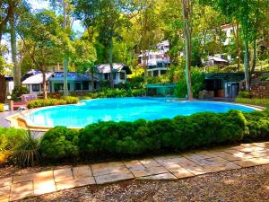 a large swimming pool in a yard with trees and houses at B.92b in Ban Ko Kok
