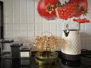 a kitchen counter with a blender and tomatoes on the wall at Karimbek Guest house by SamApart in Samarkand