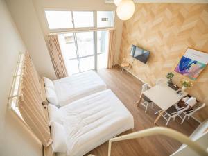 a hospital room with a bed and a table at Hotel Tomas Asahibashi Station in Naha