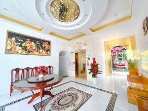 a dining room with a table and a ceiling at Phong Dung Beach Hotel Phan Ri Cua in Tuy Phong