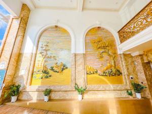a room with a large painting on the wall at Phong Dung Beach Hotel Phan Ri Cua in Tuy Phong