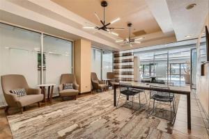 an office with chairs and a table and windows at Comfortable 1 Bed 1 Bath Loft in Uptown Denver in Denver