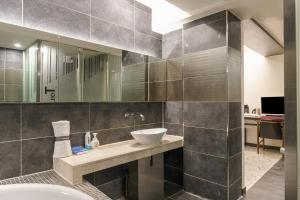 a bathroom with a sink and a mirror at Hip Hotel in Seoul