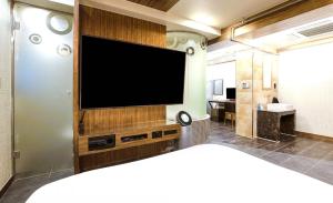 a living room with a flat screen tv on a wall at Hip Hotel in Seoul +46 photos