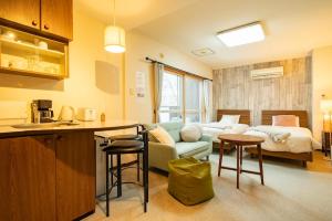 a kitchen and living room with a couch and a bed at Fewdays Condominium108 in Sapporo +55 photos