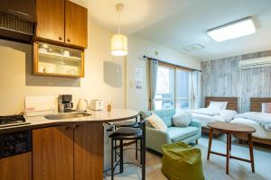 a room with a kitchen and a living room at Fewdays Condominium108 in Sapporo
