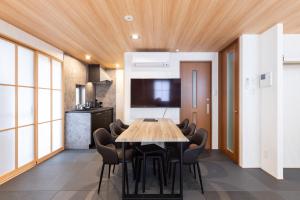 a kitchen and dining room with a table and chairs at WeskiiHotel in Kanazawa