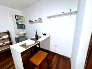 a small kitchen with a white counter and a table at Avaroa 350 express in Sucre