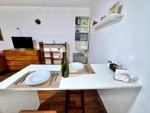 a white table with two plates and a bottle on it at Avaroa 350 express in Sucre