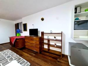a living room with a tv and a dresser at Avaroa 350 express in Sucre