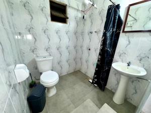 a bathroom with a toilet and a sink at Avaroa 350 express in Sucre