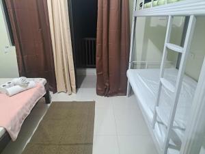 a small room with a bunk bed and a rug at Brenthill Condo Ruby unit in Baguio