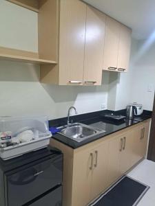 a kitchen with a sink and a counter top at Brenthill Condo Ruby unit in Baguio