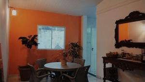 a dining room with a table and a mirror at Quarto privativo em casa compartilhada in Aracaju