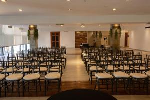 a room with rows of chairs in a hall at Hotel Gilfer Puebla Centro Histórico in Puebla