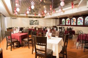 a dining room with tables and chairs and stained glass windows at Hotel Gilfer Puebla Centro Histórico in Puebla