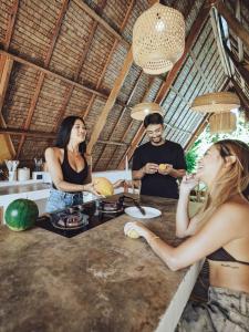 a group of people standing around a kitchen counter at Vibes Villas Siargao in General Luna