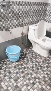 a bathroom with a toilet and a bucket at Sintra Villa in Meppādi +10 photos