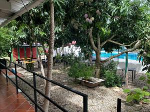a resort with a pool and trees and a fence at Casa Campestre Kostal Azul in Tocaima