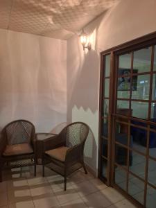a room with two chairs and a table and a window at Casa Margarita in Santiago +5 photos