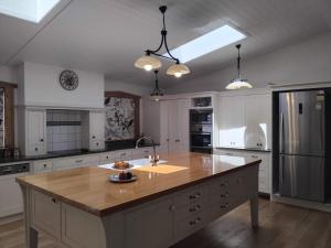 a large kitchen with a large island in the middle at LLU Homes in Westport