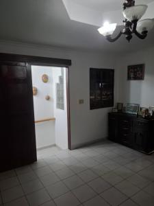 a living room with a door open to a room at Casa Margarita in Santiago