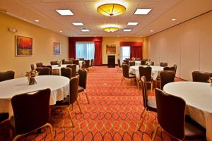 a conference room with tables and chairs and a podium at Holiday Inn Express-International Drive by IHG in Orlando +83 photos