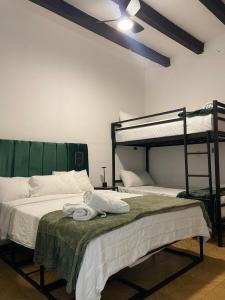 a bedroom with two bunk beds and towels on a bed at Hotel PATIO ZARAGOZA, Centro Histórico SLP in San Luis Potosí +119 photos