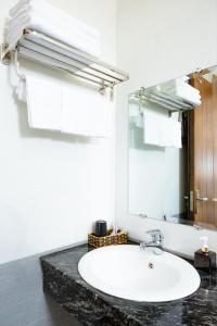 a bathroom with a white sink and a mirror at Sonne Hotel Quang Binh in Dong Hoi +12 photos