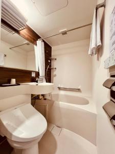 a bathroom with a toilet and a sink and a tub at Osaka03 地铁站步行两分钟 直达难波 日本桥 梅田 关西机场 in Osaka +44 photos
