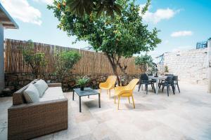 a patio with a couch and chairs and a table at חקל תפוחין 1 - Hakal-Tapuchin 1 in Safed