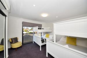 a bedroom with two bunk beds and a balcony at Bliss On Pearl Key in Gold Coast