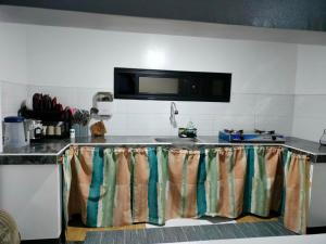 a kitchen with a sink and a counter top at casita de flocerfida in Boac