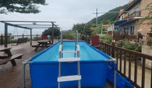 a swimming pool with a ladder in the middle at Yeonggwang Chohyeon Pension in Yeonggwang