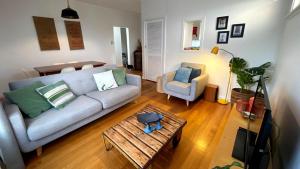 a living room with a couch and a coffee table at Driftwood in Venus Bay