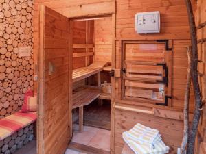 a wooden cabin with a sauna at Tranquil Holiday Home in Reinerzau with Terrace and Garden in Alpirsbach