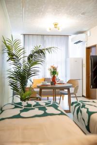 a living room with a table and a dining room at 森 BREEZE furano MORI in Furano